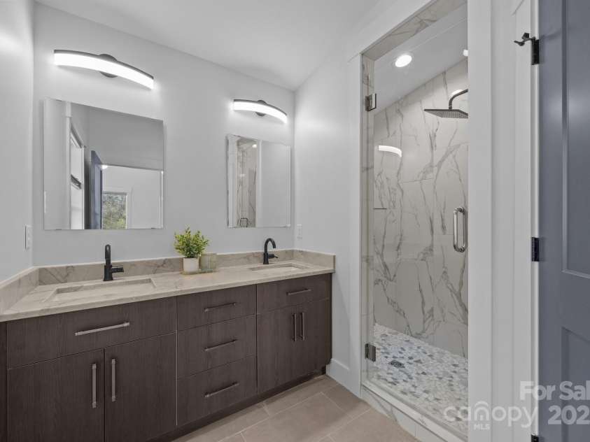 87 Glendale Avenue, Asheville, NC 28803.  MLS# CAR4145550, YatesRealty ID 2125. Primary bath features a walk in shower with rain head fixture