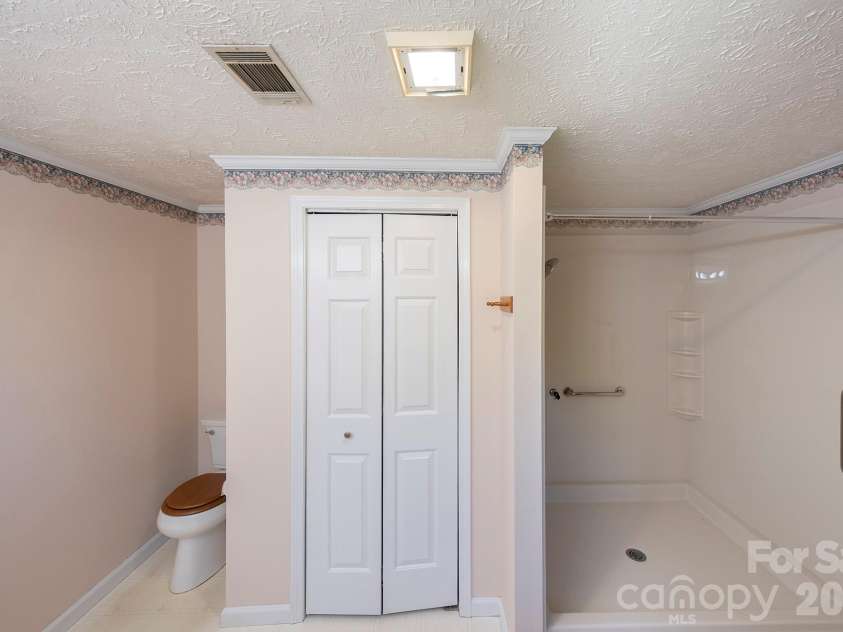 132 Serenity Circle, Hendersonville, NC 28792.  MLS# CAR4378442, YatesRealty ID 21270. PRIMARY BATHROOM W -ROLL UP SHOWER