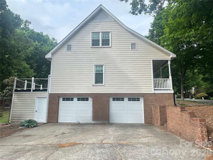 4116 Moss Brook Drive, Winston Salem, NC 27127.  MLS# CAR4380282, YatesRealty ID 21288. Side view 2 car basement garage