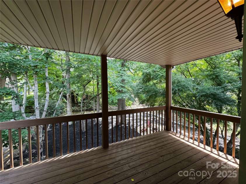 84 Indian Trace, Maggie Valley, NC 28751.  MLS# CAR4272235, YatesRealty ID 21289. Covered porch overlooks creek from 3rd bedroom
