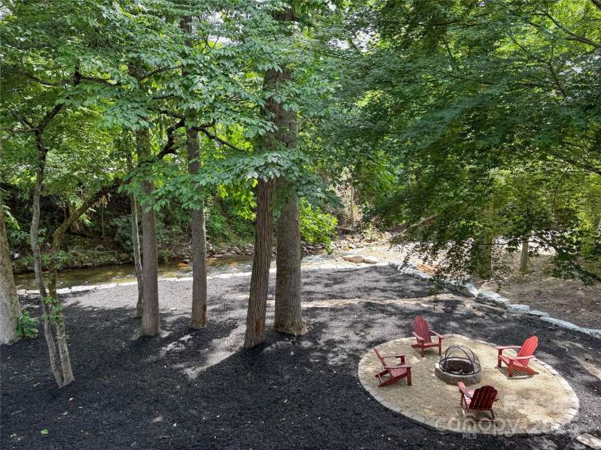 84 Indian Trace, Maggie Valley, NC 28751.  MLS# CAR4272235, YatesRealty ID 21289. Creek beside the fire pit