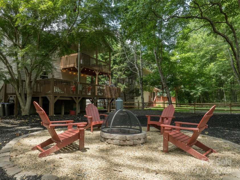 84 Indian Trace, Maggie Valley, NC 28751.  MLS# CAR4272235, YatesRealty ID 21289. Fire pit close to the house