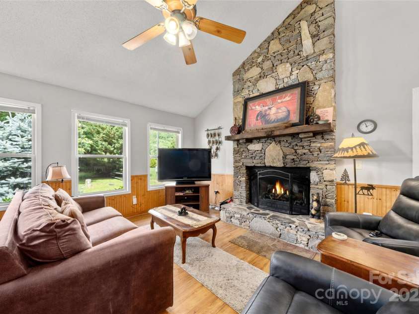 84 Indian Trace, Maggie Valley, NC 28751.  MLS# CAR4272235, YatesRealty ID 21289. Great Room next to BOLD Jonathan Creek 84 Indian Trace, Maggie Valley NC