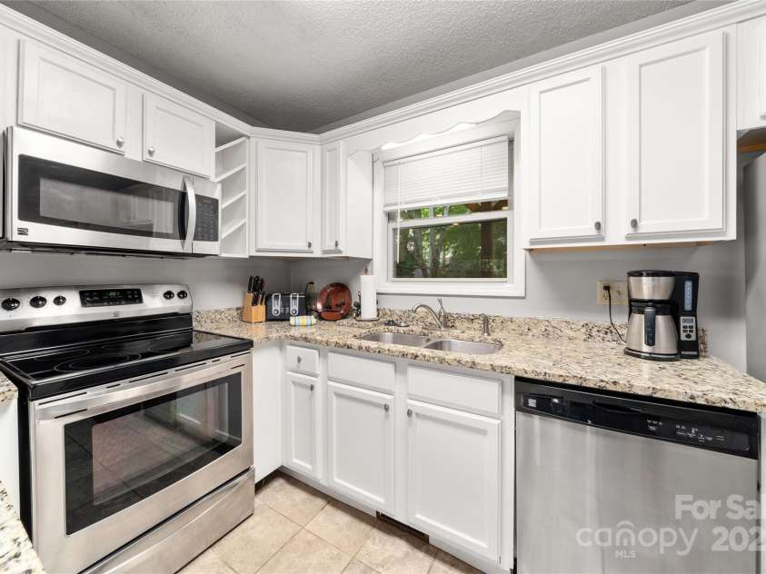 84 Indian Trace, Maggie Valley, NC 28751.  MLS# CAR4272235, YatesRealty ID 21289. Kitchen window overlooks back porch and the creek