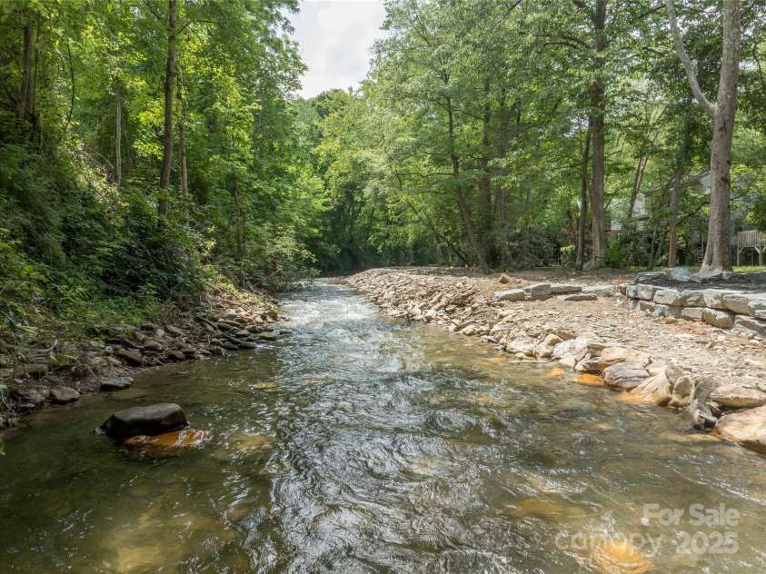 84 Indian Trace, Maggie Valley, NC 28751.  MLS# CAR4272235, YatesRealty ID 21289. Trout Fishing stream in back yard