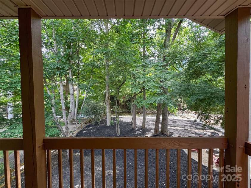 84 Indian Trace, Maggie Valley, NC 28751.  MLS# CAR4272235, YatesRealty ID 21289. View of creek from upper covered porch