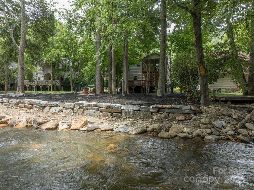84 Indian Trace, Maggie Valley, NC 28751.  MLS# CAR4272235, YatesRealty ID 21289. View of House from the Creek