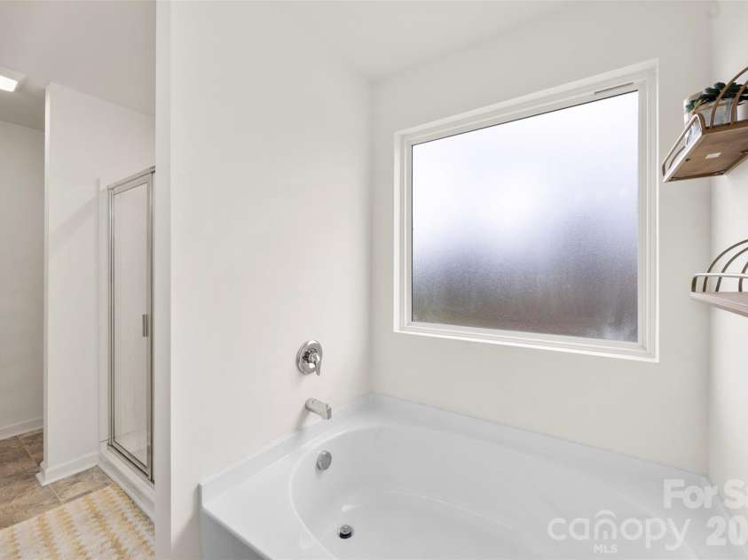 717 Lexington Drive, Albemarle, NC 28001.  MLS# CAR4345706, YatesRealty ID 21291. Soaking tub with natural light through the window! 