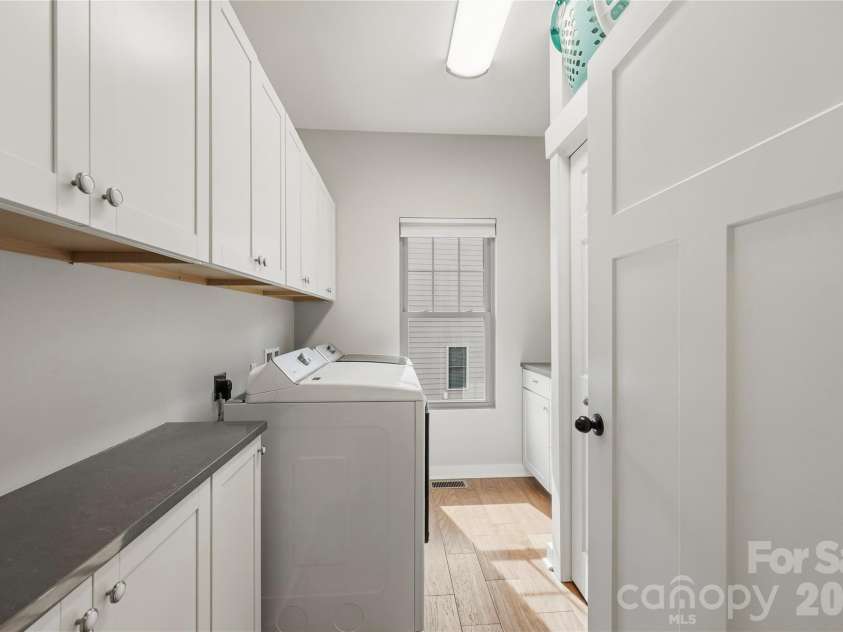 646 13th Avenue Place, Hickory, NC 28601.  MLS# CAR4378642, YatesRealty ID 21295. Laundry with extra cabinets and hanging rack