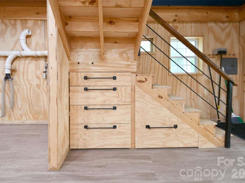 4484 Ranchway Drive, Concord, NC 28027.  MLS# CAR4375185, YatesRealty ID 21305. Custom-built staircase with integrated storage drawers, maximizing organization and utility within the workspace