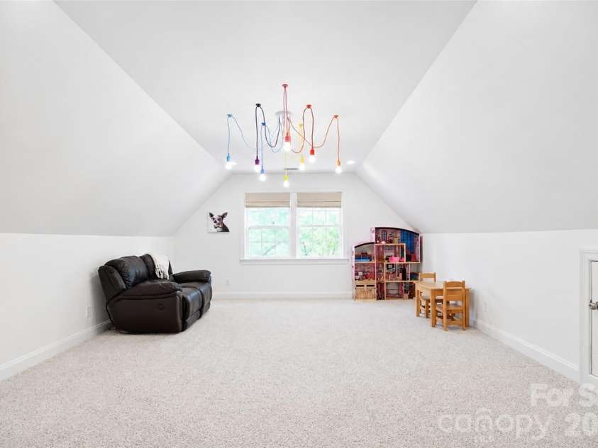 4484 Ranchway Drive, Concord, NC 28027.  MLS# CAR4375185, YatesRealty ID 21305. Expansive bonus room with vaulted ceilings, perfect for playroom, media, or flex space