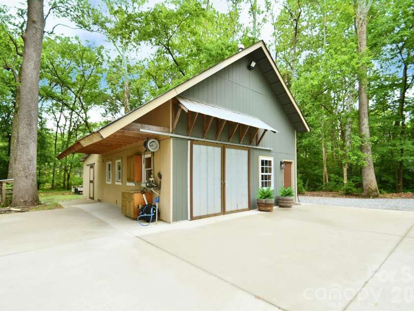 4484 Ranchway Drive, Concord, NC 28027.  MLS# CAR4375185, YatesRealty ID 21305. Impressive 1,600+ sq ft two-level workshop with wide concrete apron and oversized entry, offering ample space for projects, equipment, and parking