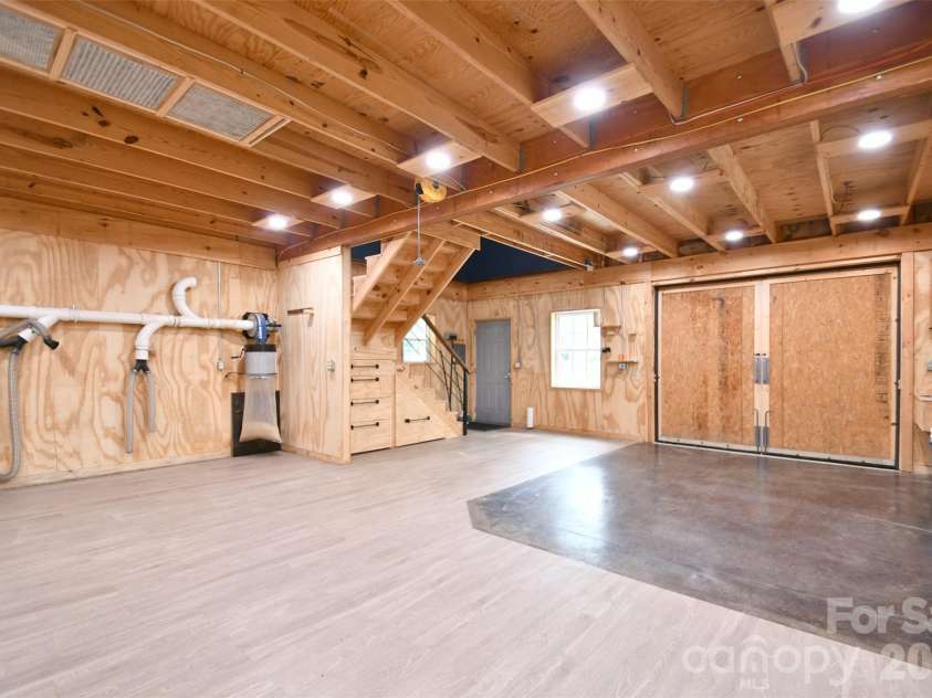 4484 Ranchway Drive, Concord, NC 28027.  MLS# CAR4375185, YatesRealty ID 21305. Large workshop with oversized access doors, built-in dust collection system (negotiable), and staircase leading to upper level