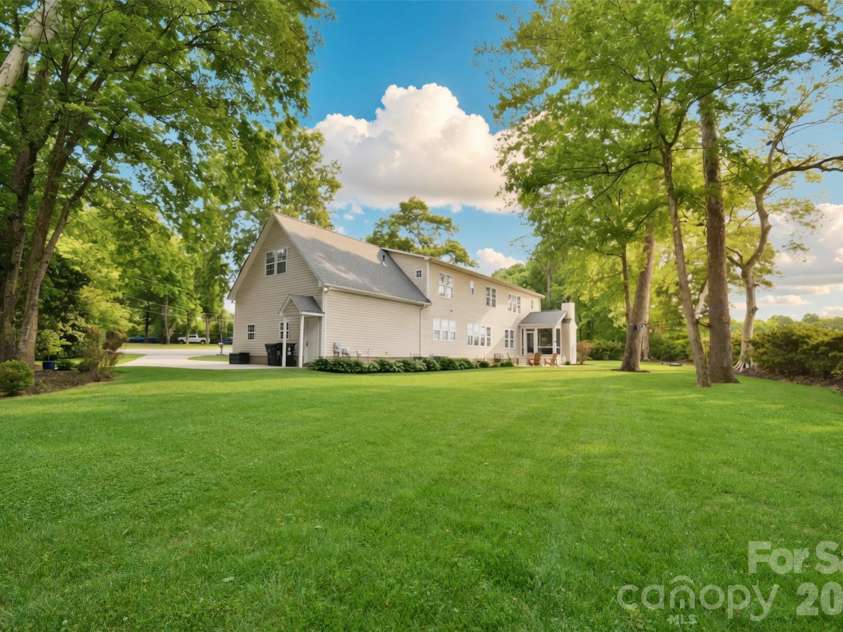 4484 Ranchway Drive, Concord, NC 28027.  MLS# CAR4375185, YatesRealty ID 21305. Private,backyard with mature trees and wide-open green space, offering the perfect setting for relaxation, play, or entertaining