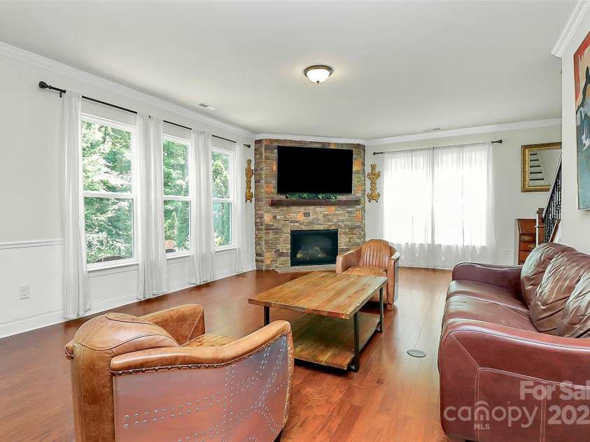 7011 Hyde Park Drive, Indian Trail, NC 28079.  MLS# CAR4268661, YatesRealty ID 21323. Open living room across rear of the home overlooks park like yard