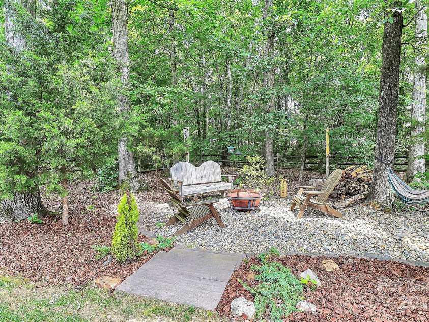 7011 Hyde Park Drive, Indian Trail, NC 28079.  MLS# CAR4268661, YatesRealty ID 21323. Peaceful tree shaded gathering spot around the firepit