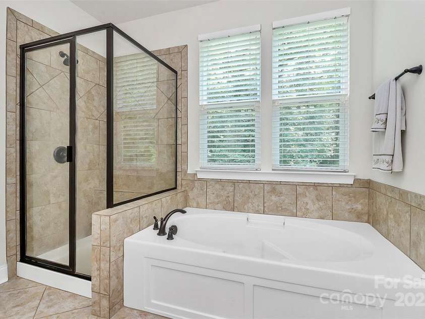 7011 Hyde Park Drive, Indian Trail, NC 28079.  MLS# CAR4268661, YatesRealty ID 21323. Primary bathroom with stand up shower and separate tub