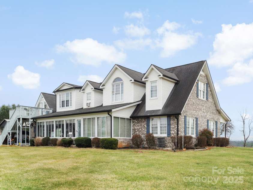 727 Jenkins Valley Road, Alexander, NC 28701.  MLS# CAR4235182, YatesRealty ID 21342. Back view of house featuring the sunroom