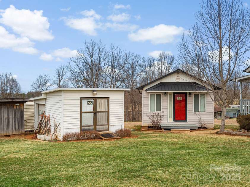 727 Jenkins Valley Road, Alexander, NC 28701.  MLS# CAR4235182, YatesRealty ID 21342. Lots of potential for these two great wired outbuildings for workshop or studio.