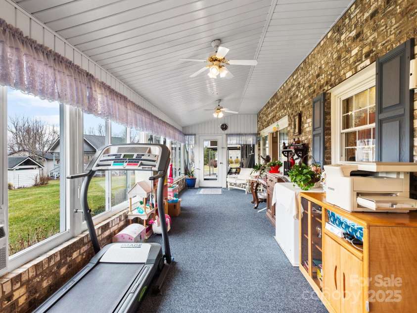 727 Jenkins Valley Road, Alexander, NC 28701.  MLS# CAR4235182, YatesRealty ID 21342. Spacious sunroom.