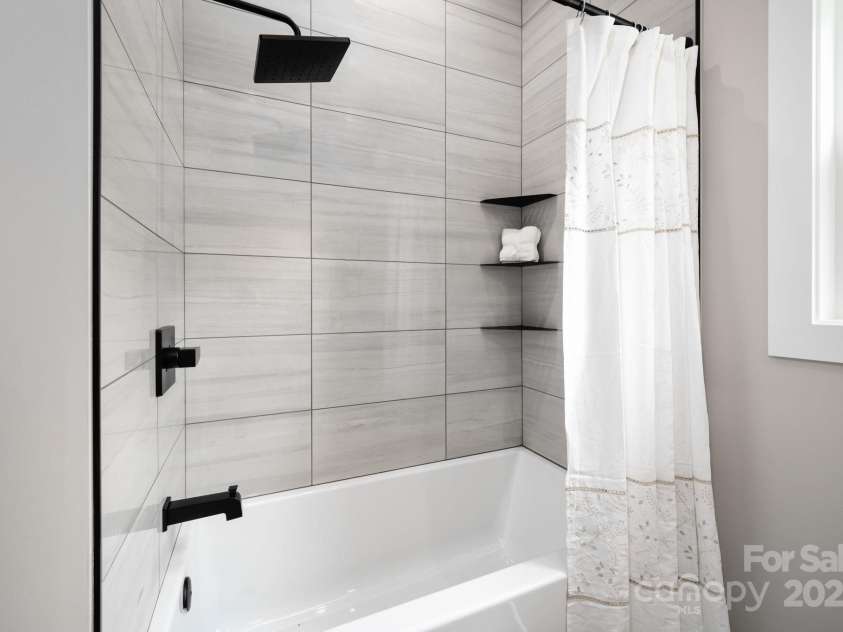 9 Robey Drive, Fletcher, NC 28732.  MLS# CAR4261327, YatesRealty ID 21353. Shower Tub combo with porcelain tile