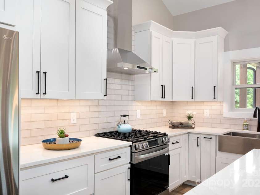 9 Robey Drive, Fletcher, NC 28732.  MLS# CAR4261327, YatesRealty ID 21353. Stainless Gas Range and Vent Hood