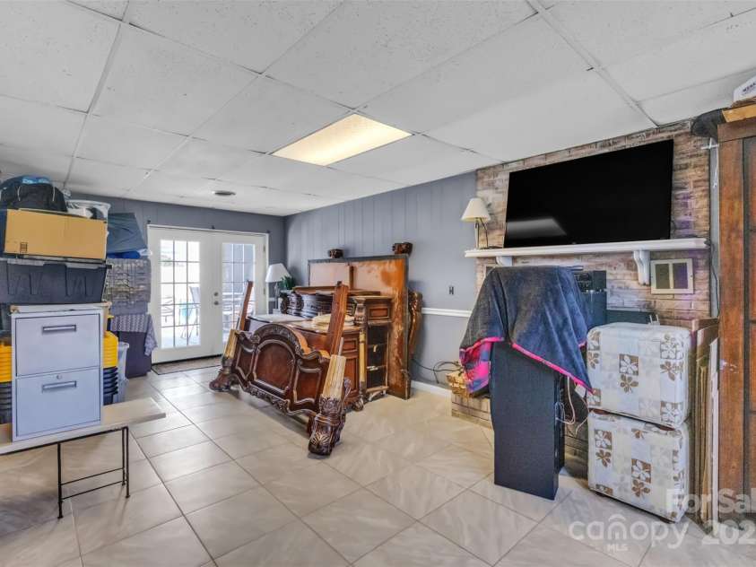 1 Plaza Drive, Granite Falls, NC 28630.  MLS# CAR4263385, YatesRealty ID 21372. Basement Main Living Area with French Doors to Pool