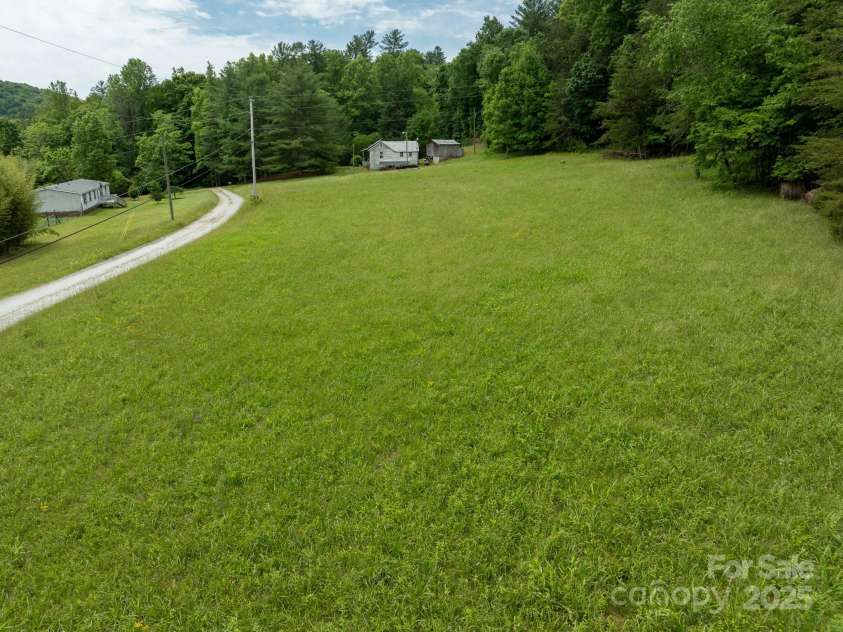 2023 White Springs Lane, Lenoir, NC 28645.  MLS# CAR4266812, YatesRealty ID 21383. Cleared, level view looking toward farmhouse