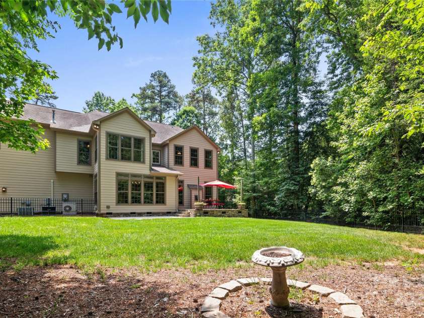 14130 Lea Point Court, Huntersville, NC 28078.  MLS# CAR4247240, YatesRealty ID 21385. Backyard looking at the house from the little bench.