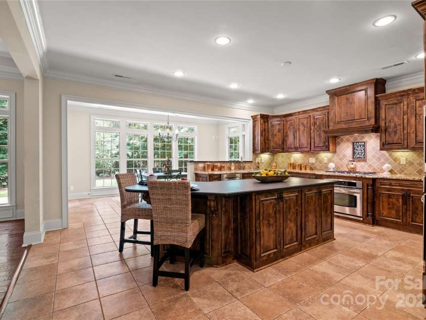 14130 Lea Point Court, Huntersville, NC 28078.  MLS# CAR4247240, YatesRealty ID 21385. Beautiful kitchen with massive island with leathered granite counter, seating & lots of room for cooking and entertaining.