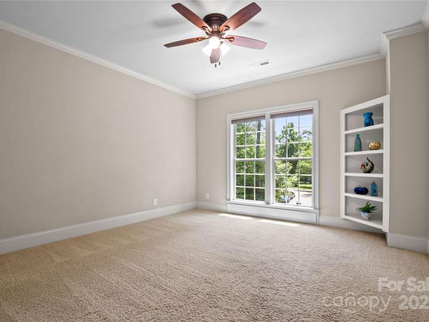 14130 Lea Point Court, Huntersville, NC 28078.  MLS# CAR4247240, YatesRealty ID 21385. Front bedroom 2 features custom built-in shelves, ceiling fan and large closet.