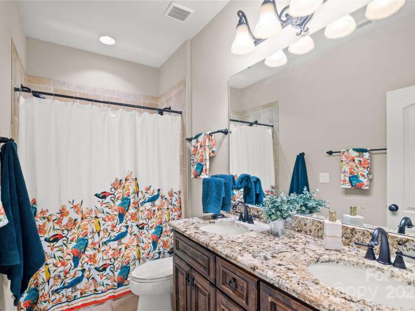 14130 Lea Point Court, Huntersville, NC 28078.  MLS# CAR4247240, YatesRealty ID 21385. Hall bathroom with granite countertops, 2 sinks & tub with 2 shower controls!