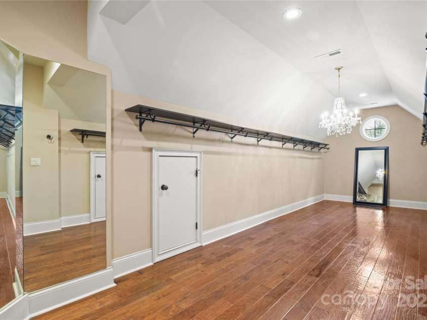 14130 Lea Point Court, Huntersville, NC 28078.  MLS# CAR4247240, YatesRealty ID 21385. Huge closet in the primary bedroom with elegant crystal chandelier. There is also a ton of storage behind the two short storage doors.