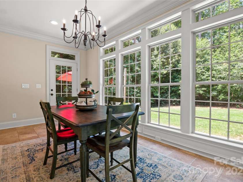 14130 Lea Point Court, Huntersville, NC 28078.  MLS# CAR4247240, YatesRealty ID 21385. So many windows in the sunroom. The door leads out to the flagstone upper patio.