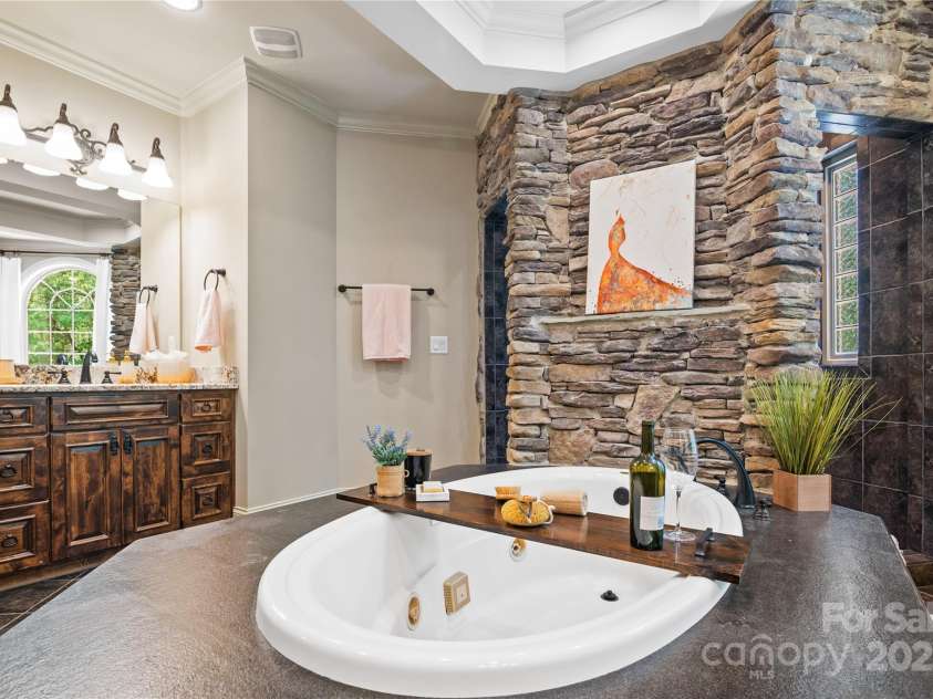 14130 Lea Point Court, Huntersville, NC 28078.  MLS# CAR4247240, YatesRealty ID 21385. The focal point is the Jacuzzi tub in the center of the bathroom.