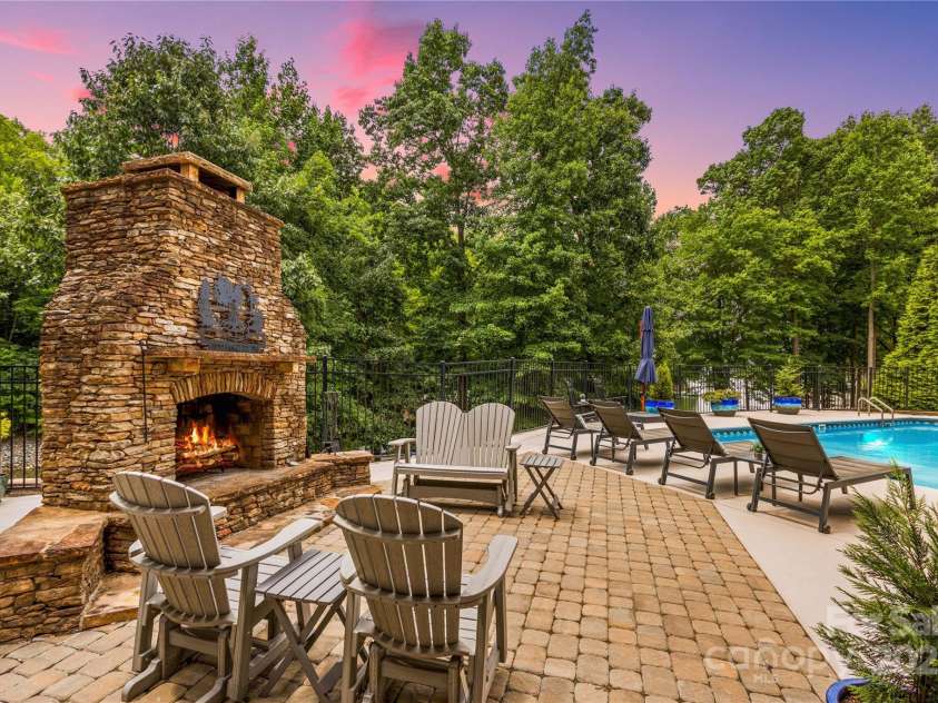 183 April Road, Troutman, NC 28166.  MLS# CAR4158487, YatesRealty ID 2139. Fireplace and several seating areas, Poolside