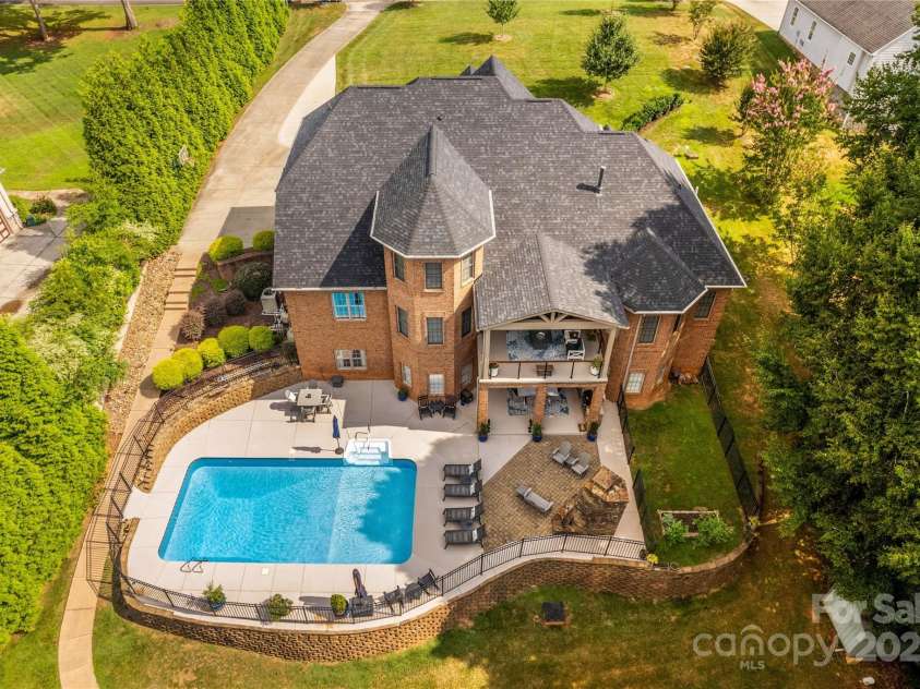 183 April Road, Troutman, NC 28166.  MLS# CAR4158487, YatesRealty ID 2139. View of Home and Pool, on Private Waterfront Lot