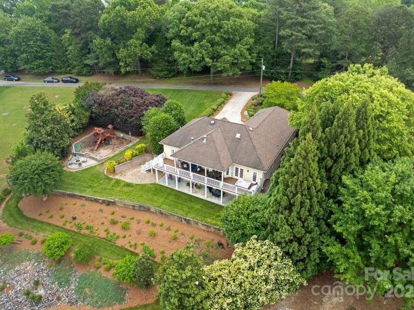 7471 Barfield Lane, Denver, NC 28037.  MLS# CAR4250519, YatesRealty ID 21396. .8 Acres of lakefront living includes play area with put-put, fire pit, extended deck and covered patio!