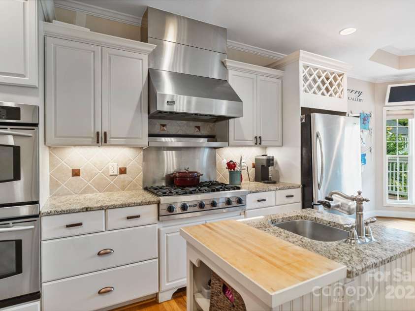 7471 Barfield Lane, Denver, NC 28037.  MLS# CAR4250519, YatesRealty ID 21396. Stainless steel appliances, including gas cooktop and double ovens.