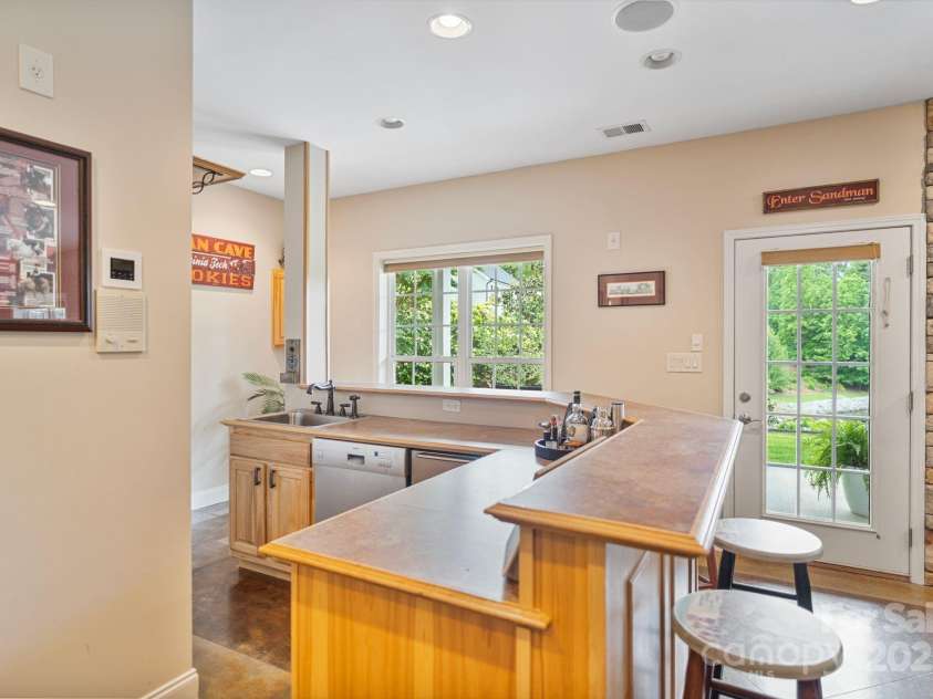7471 Barfield Lane, Denver, NC 28037.  MLS# CAR4250519, YatesRealty ID 21396. Wet bar offers, sink, dishwasher and beverage fridge.