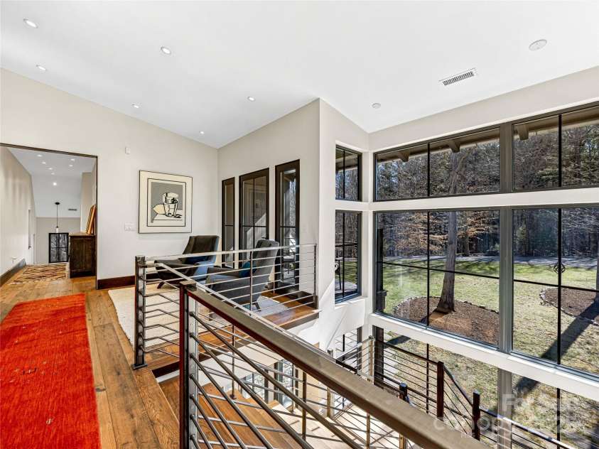 18 Wolfe Cove Road, Asheville, NC 28804.  MLS# CAR4231341, YatesRealty ID 21400. 2nd floor of the home includes a sitting area, den, massive primary suite, and two additional guest bedrooms with shared bathroom.
