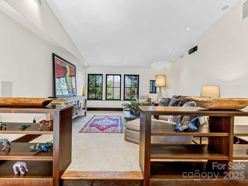 18 Wolfe Cove Road, Asheville, NC 28804.  MLS# CAR4231341, YatesRealty ID 21400. Upstairs raised den equipped with projector and ceiling-recessed projection screen, perfect for cozy movie nights.