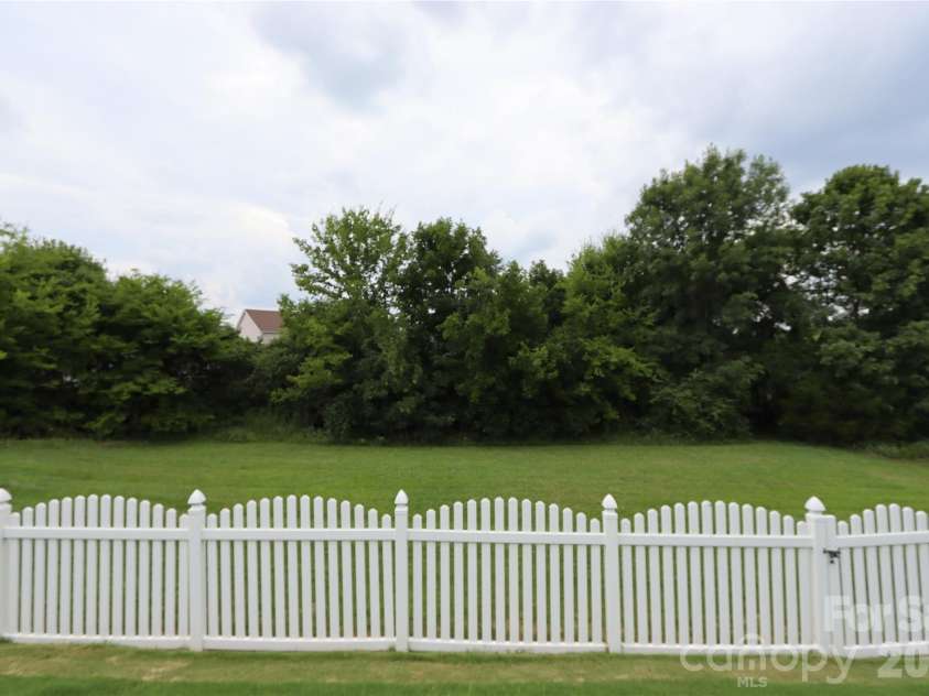 3586 Larkhaven Avenue, Concord, NC 28027.  MLS# CAR4398319, YatesRealty ID 21400. Fenced in with wooded buffer.