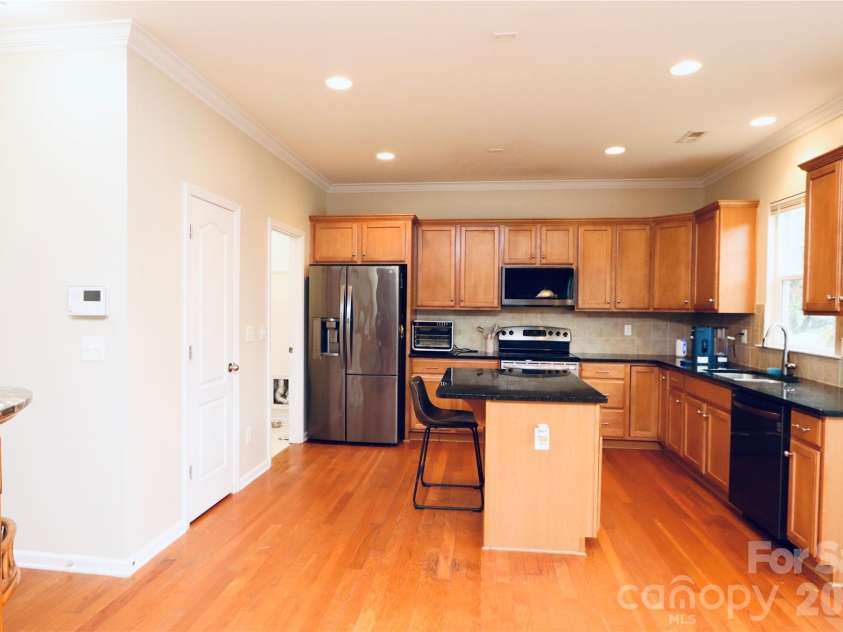 3586 Larkhaven Avenue, Concord, NC 28027.  MLS# CAR4398319, YatesRealty ID 21400. Large kitchen with island & stainless steel appliances