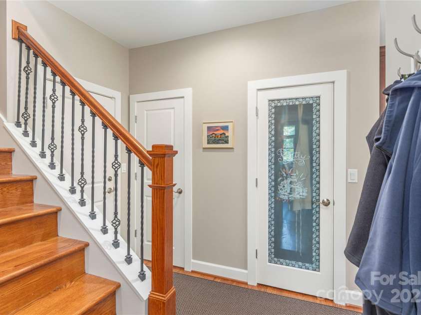 930 Big Raven Lane, Saluda, NC 28773.  MLS# CAR4270163, YatesRealty ID 21407. Stairs from the kitchen/laundry area to the F.R.O.G. Finished Room Over Garage
