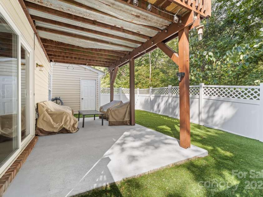 1542 Maypine Commons Way, Rock Hill, SC 29732.  MLS# CAR4303451, YatesRealty ID 21408. Patio covered by deck above and storage closet
