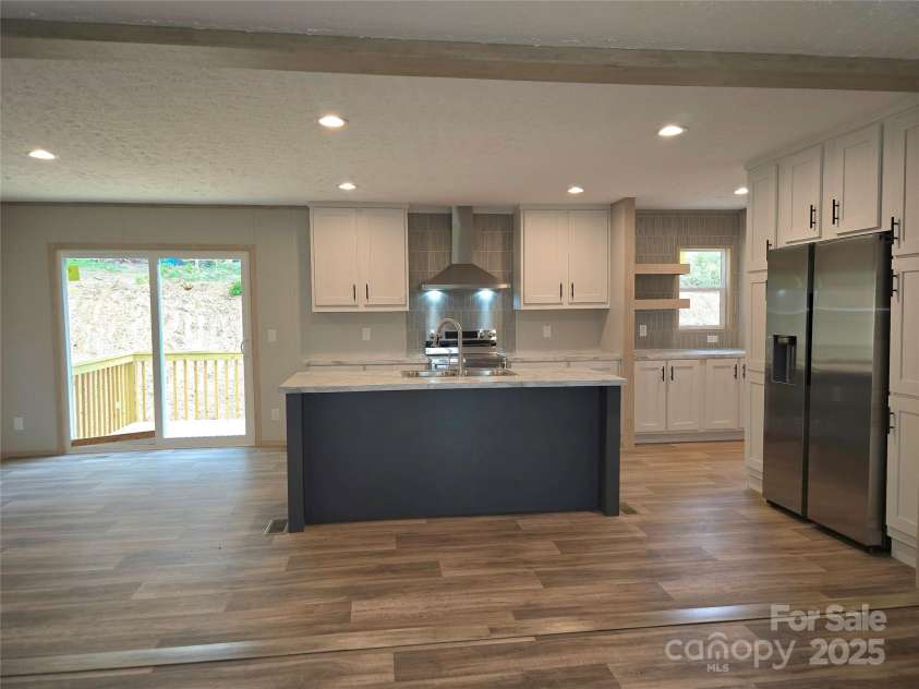28 McGee Hill Road, Fairview, NC 28730.  MLS# CAR4234757, YatesRealty ID 21416. View into kitchen from living room.