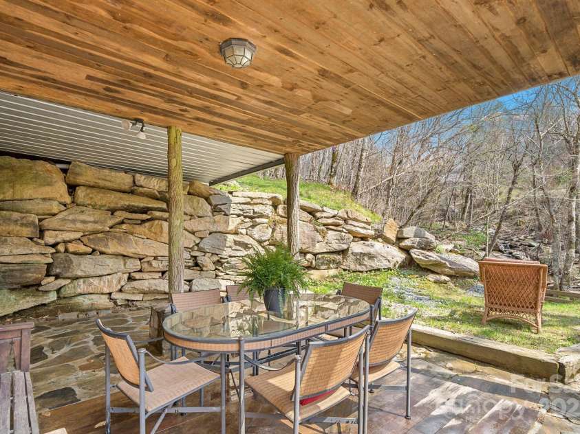 140 Spruce Hollow Road, Beech Mountain, NC 28604.  MLS# CAR4263469, YatesRealty ID 21427. Covered Patio Over Looking Creek