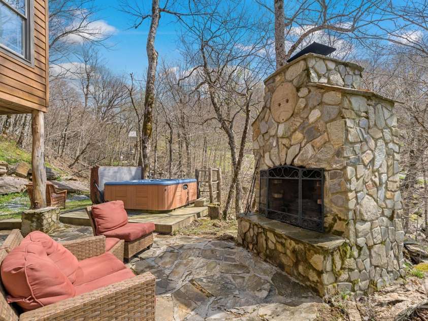 140 Spruce Hollow Road, Beech Mountain, NC 28604.  MLS# CAR4263469, YatesRealty ID 21427. Fireplace and Hot tub Overlooking Creek