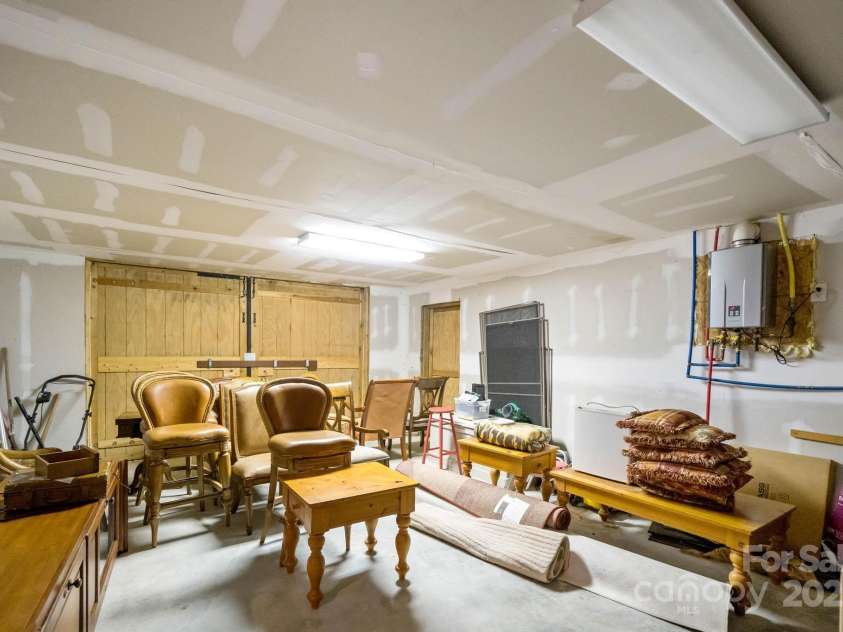 140 Spruce Hollow Road, Beech Mountain, NC 28604.  MLS# CAR4263469, YatesRealty ID 21427. Garage with Additional Furniture